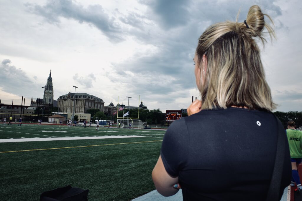 Athletic trainer Cally Beltz surveys the field for injuries.