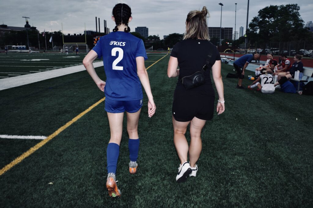 Athletic trainer Cally Beltz evaluates a player for a concussions 